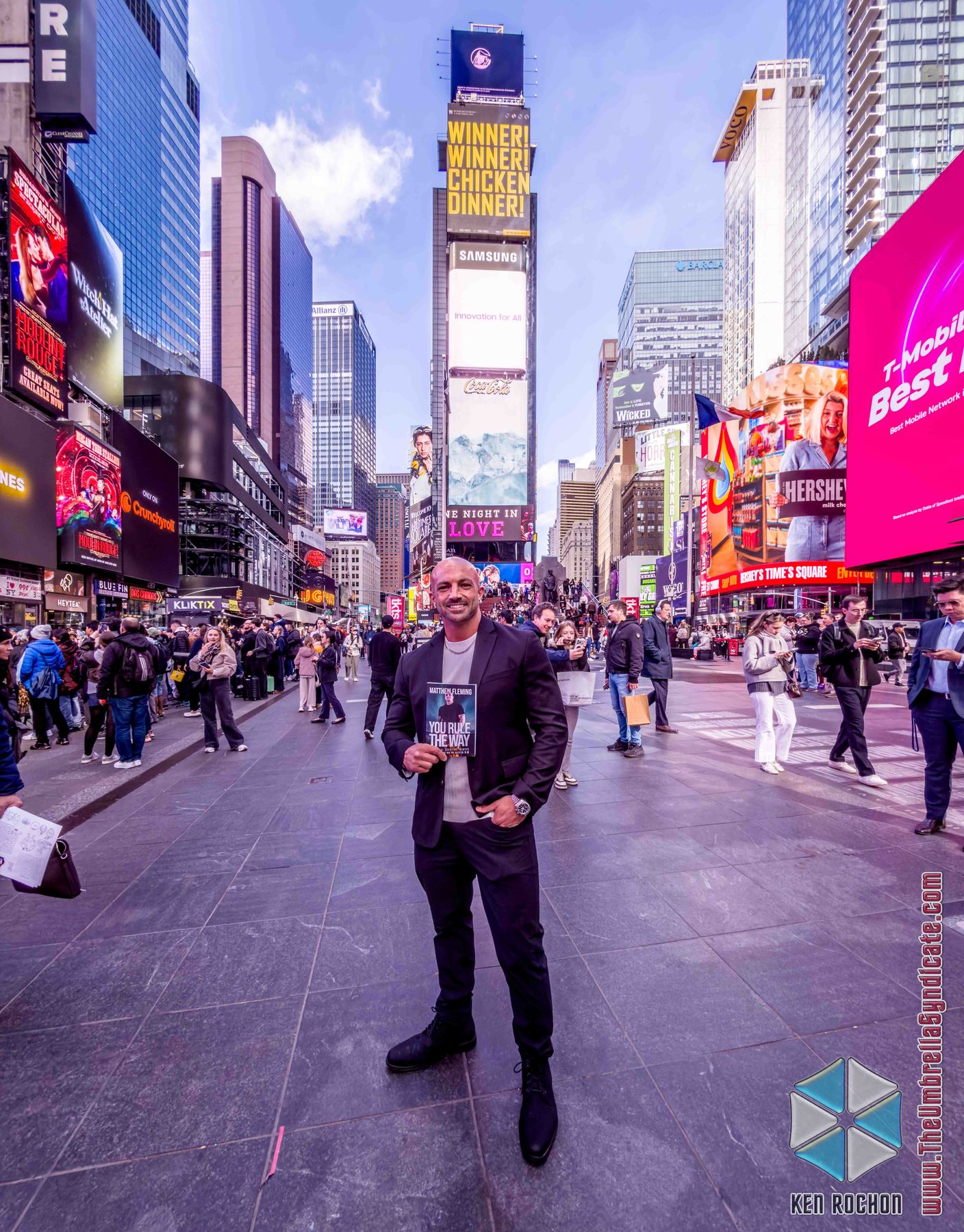 Matt Fleming in Times Square holding You Rule The Way.